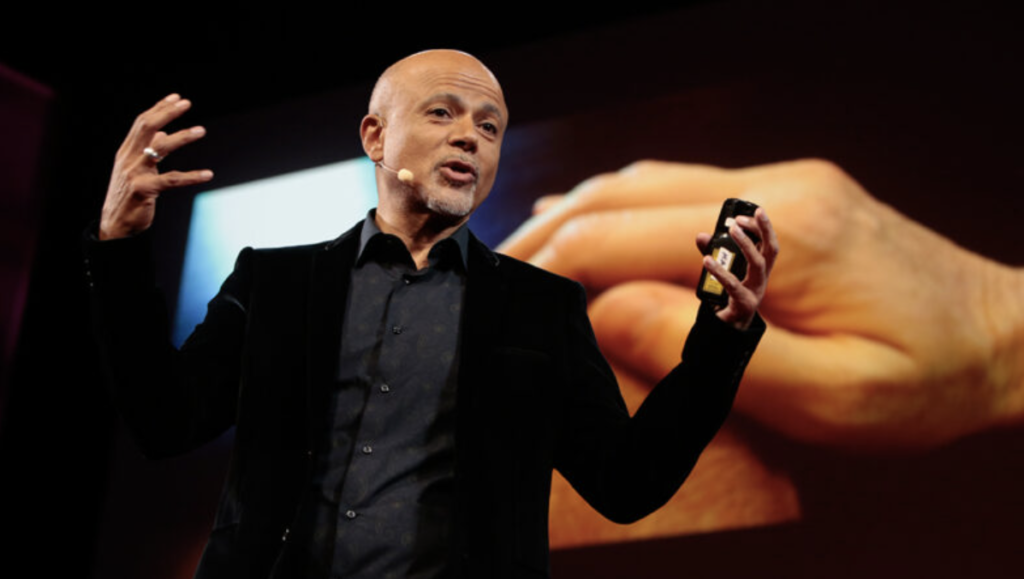 man standing on a stage giving a presentation